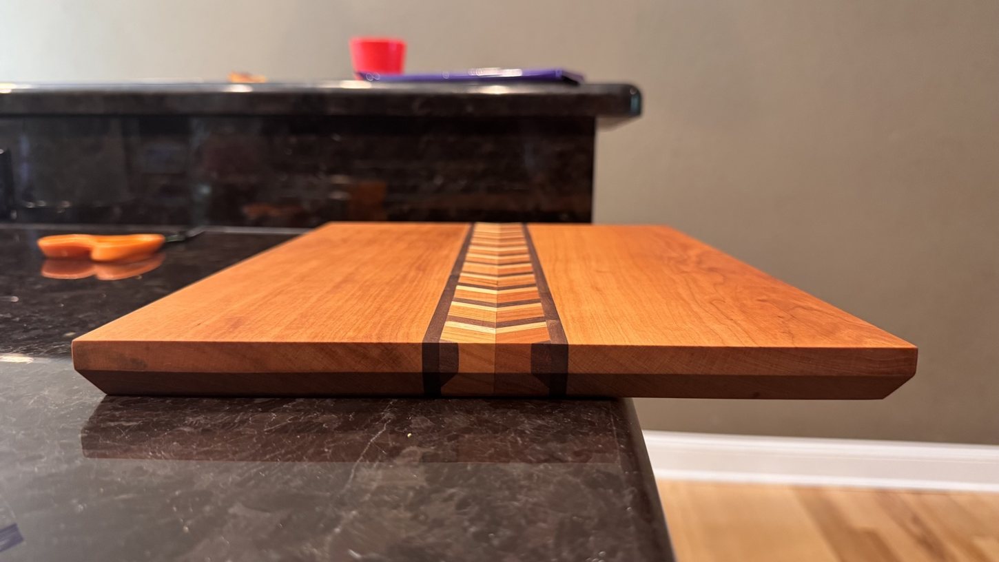 Handcrafted cutting board with a patterned center stripe