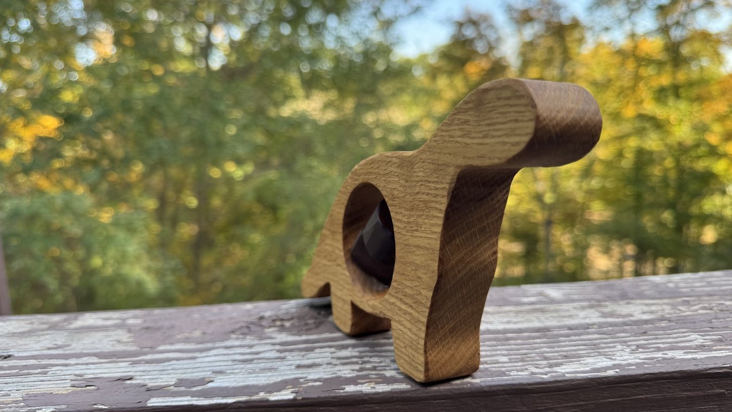 Small sculptural wood object photographed outdoors